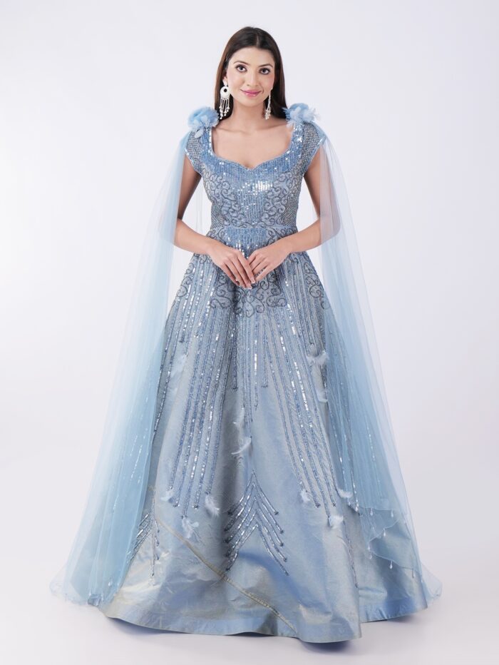 Radiate Royal Elegance In This Stunning Icy Blue Embroidered Gown with Cape Sleeves - Image 1