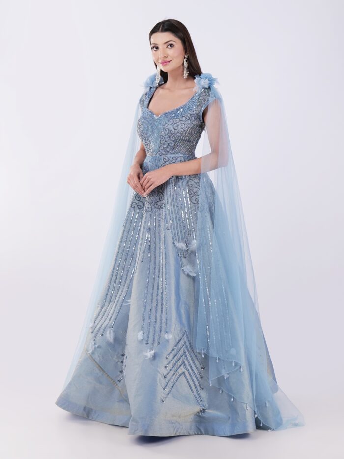 Radiate Royal Elegance In This Stunning Icy Blue Embroidered Gown with Cape Sleeves - Image 3