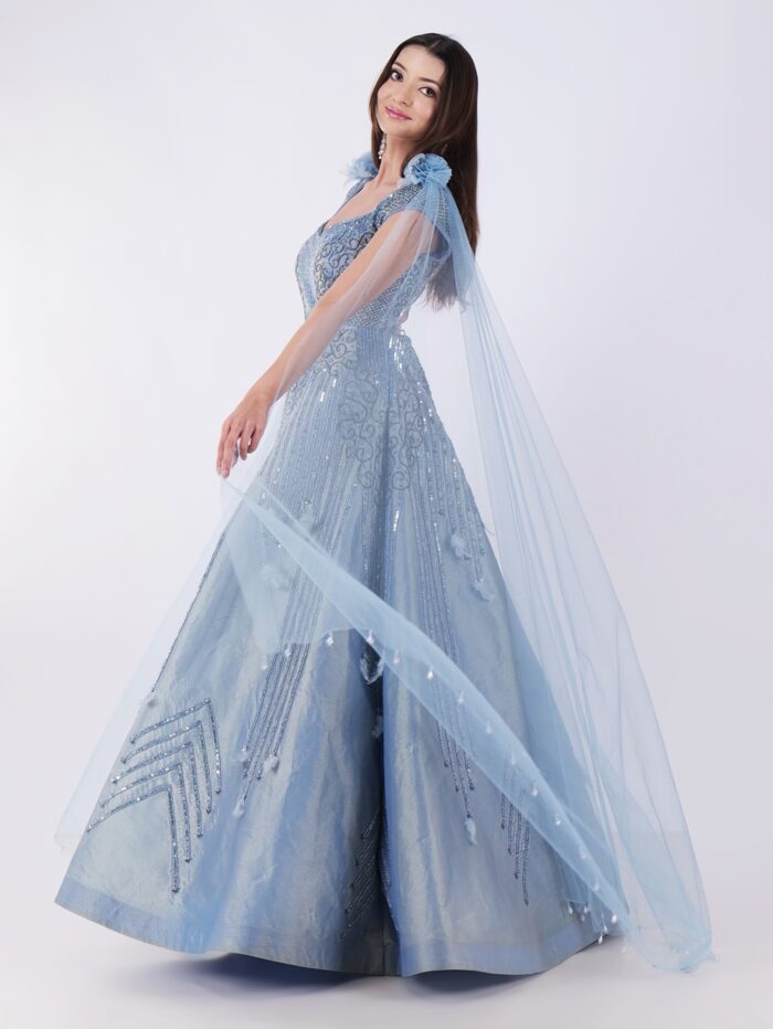 Radiate Royal Elegance In This Stunning Icy Blue Embroidered Gown with Cape Sleeves - Image 7